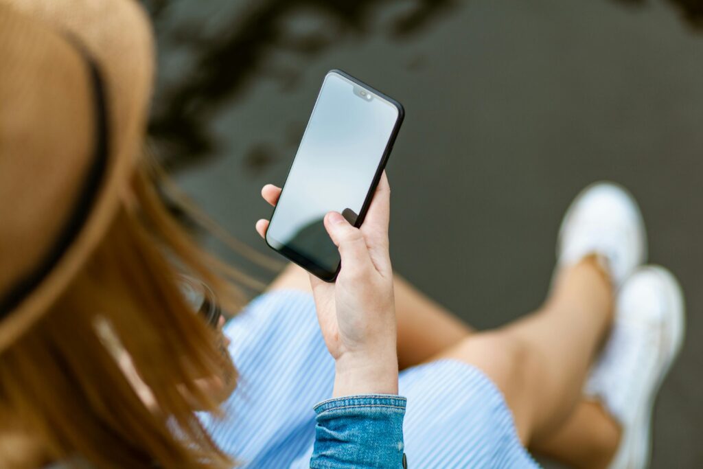pexels-photo-1310532-1310532 Person Holding Smartphone White Sitting